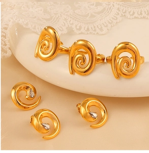 Close-up of a gold-plated twisted jewelry set with necklace and zircon earrings