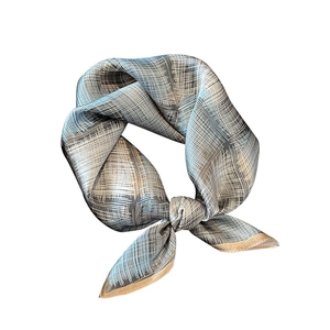 Gray-blue silk square scarf with gold plaid pattern and elegant knot on white backdrop