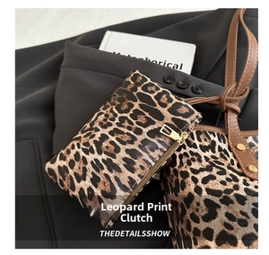 Macro shot of a leopard print mini pouch with gold zipper and textured faux leather surface