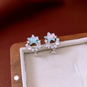 Elegant star-shaped drop earrings with blue opal and pearls in a jewelry display box
