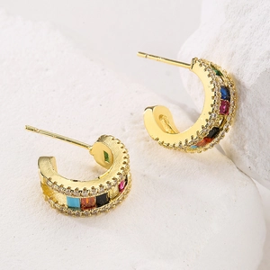 18K gold plated C-shaped earrings with colorful zircon stones on a white stone background