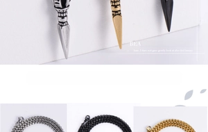 Close-up of retro cylinder pendants in silver, gold, and black with box chains