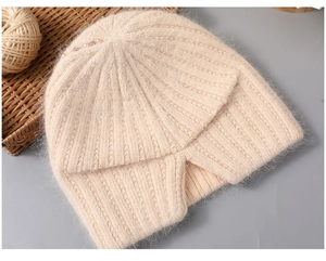 Detail of beige knit hat featuring faux rabbit fur texture and elegant pearl accents