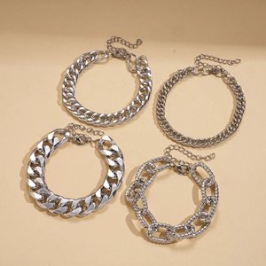 Detail of four silver-tone metal chain bracelets with lobster clasps and extension chains
