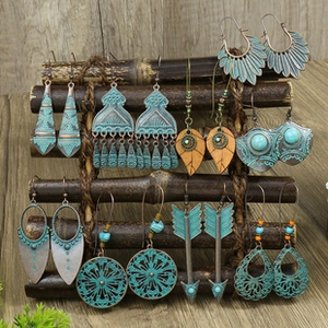 Detail of bohemian earrings set featuring vintage bronze finish and turquoise stone accents