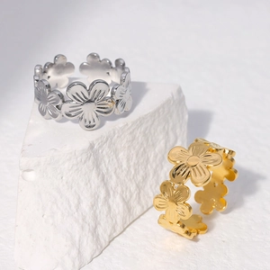 Minimalist stainless steel flower open rings in gold and silver finish on stone