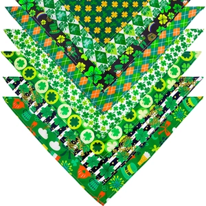 Detailed view of St. Patrick's Day pet bandanas with green shamrock prints and typography
