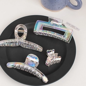Iridescent hair claw clips set in various shapes on a decorative display