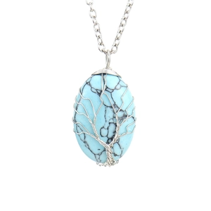 Detailed close-up of tree of life silver wire wrapped oval turquoise stone pendant