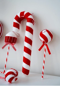 Close-up of red and white candy cane and lollipop Christmas ornaments with glitter