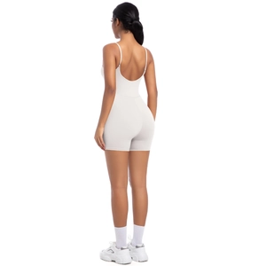 Back view of a cream-white backless sports romper with spaghetti straps and slim fit