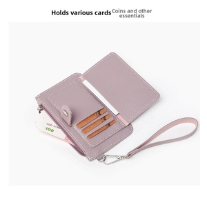 Macro detail of purple pebble leather coin purse with card slots and wristlet strap