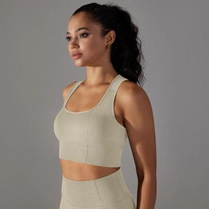 Macro detail of seamless knit beige sports bra showing breathable honeycomb fabric texture