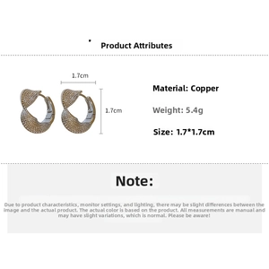 Detail view of twisted gold-colored copper earrings showing size 1.7cm and weight 5.4g