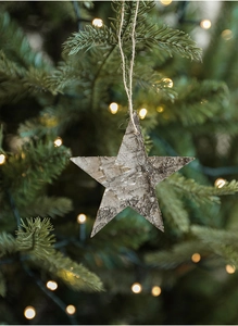 Detail of natural star-shaped birch bark wooden Christmas ornament with rustic jute rope