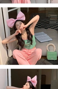 Detail of pink oversized bow headband styled with a sweet casual summer outfit