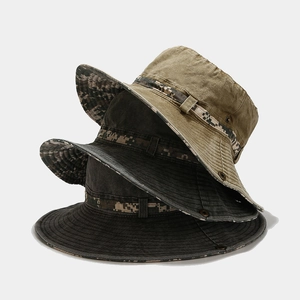 Detailed stack of washed cotton bucket hats in camo green, grey, and black colors
