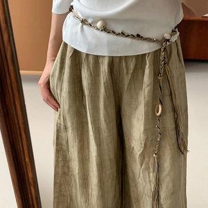 Boho tassel waist belt with vintage print and wooden beads on army green wide trousers