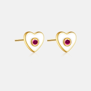 Close-up of heart-shaped S925 silver earrings with gold edges and red gems