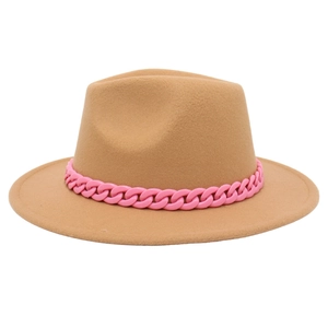 Detail of camel wide-brim fedora hat with a contrasting pink thick plastic chain