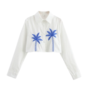White long-sleeved cropped shirt with blue coconut tree embroidery and button-up front