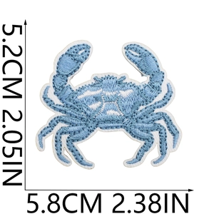 Detailed view of light blue crab embroidery patch showing precise dimensions and stitching