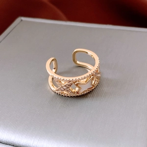 Macro view of gold-plated zircon ring with mother of pearl star on jewelry box