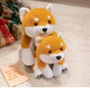 Close-up of plush Shiba Inu dog toys in two sizes with soft fur and vivid face details