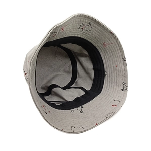 Beige corduroy bucket hat with cute dog pattern and black lining for summer sun protection
