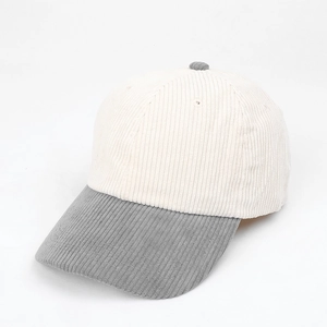Detailed view of corduroy baseball cap texture with cream crown and grey brim colors