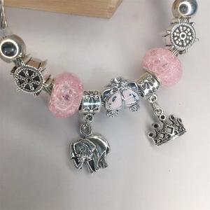 Silver bracelet for girls featuring pink glass beads with elephant and crown charms