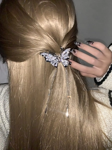 Detailed back view of a silver butterfly hair claw clip with dangling rhinestone tassels