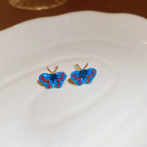 Détails de boucles d'oreilles papillon bleues avec cristaux rouges et base dorée