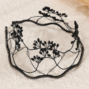 Detailed view of hand-woven bridal headband with black crystals and branch-like structure