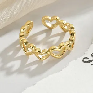 Adjustable gold plated stainless steel ring featuring linked hollow heart shapes