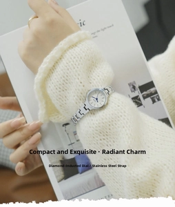 Detail of elegant silver quartz watch with diamond markers on a white dial for women