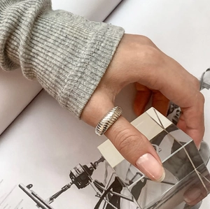 Detail of 925 sterling silver croissant ring featuring a minimalist diagonal texture
