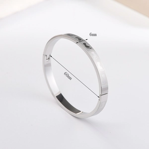 Detail view of silver steel bracelet showing 6mm width and 60mm diameter measurements