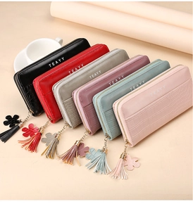 Detailed row of crocodile texture long wallets with zippers and decorative tassels