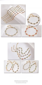 Detail of golden stainless steel heart bracelets with colorful evil eye charms in close-up