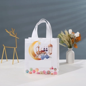 Cartoon moon festival non-woven gift bag with mosque and lantern print on a white table