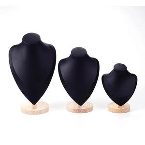 Three black bust necklace display stands with wooden bases in different sizes on white background