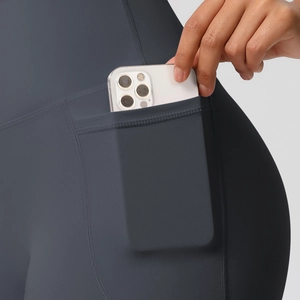 Detailed view of deep gray high waisted yoga shorts with a side phone storage pocket