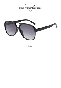 Detail view of double-bridge pilot sunglasses with black frames and gray-purple lenses