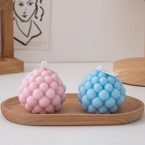 Blue and pink bubble scented candles on a wooden tray for minimalist home decor