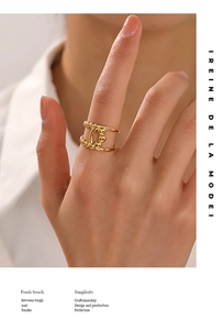 Detail of 18K gold plated hollow line ring with bead accents on a model hand