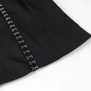 Close-up of black slimming shapewear side with metallic hook-and-eye closures on elastic fabric