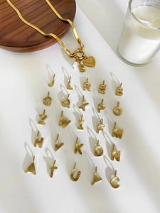 Detail of 18K gold stainless steel heart necklace with letter S and freshwater pearl