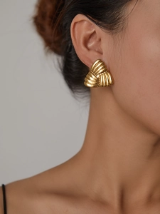 Detailed view of 18K gold plated titanium triangle earrings with shell texture