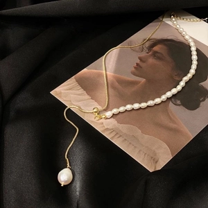 Elegant asymmetric freshwater pearl necklace with adjustable gold chain and baroque pendant